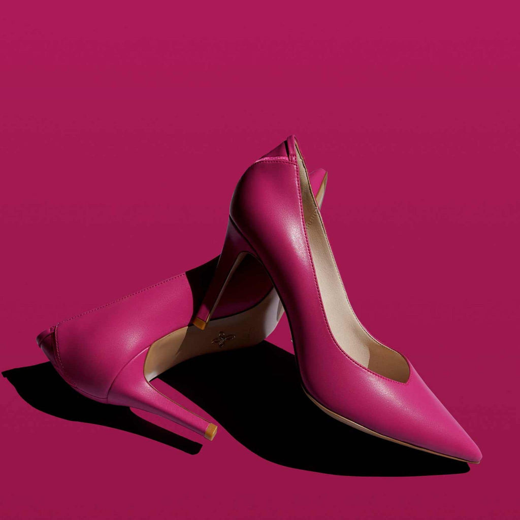 Hot pink vegan pointy toe pumps with asymmetric v-vamp for a chic design and elegant silhouette. 