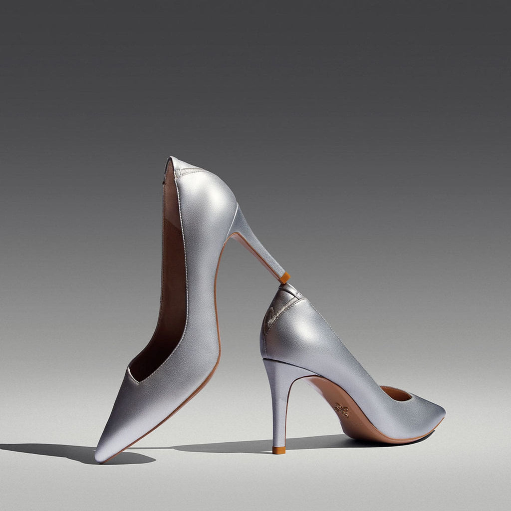 Silver vegan metallic leather pumps with a pointy toe and asymmetric v-vamp.