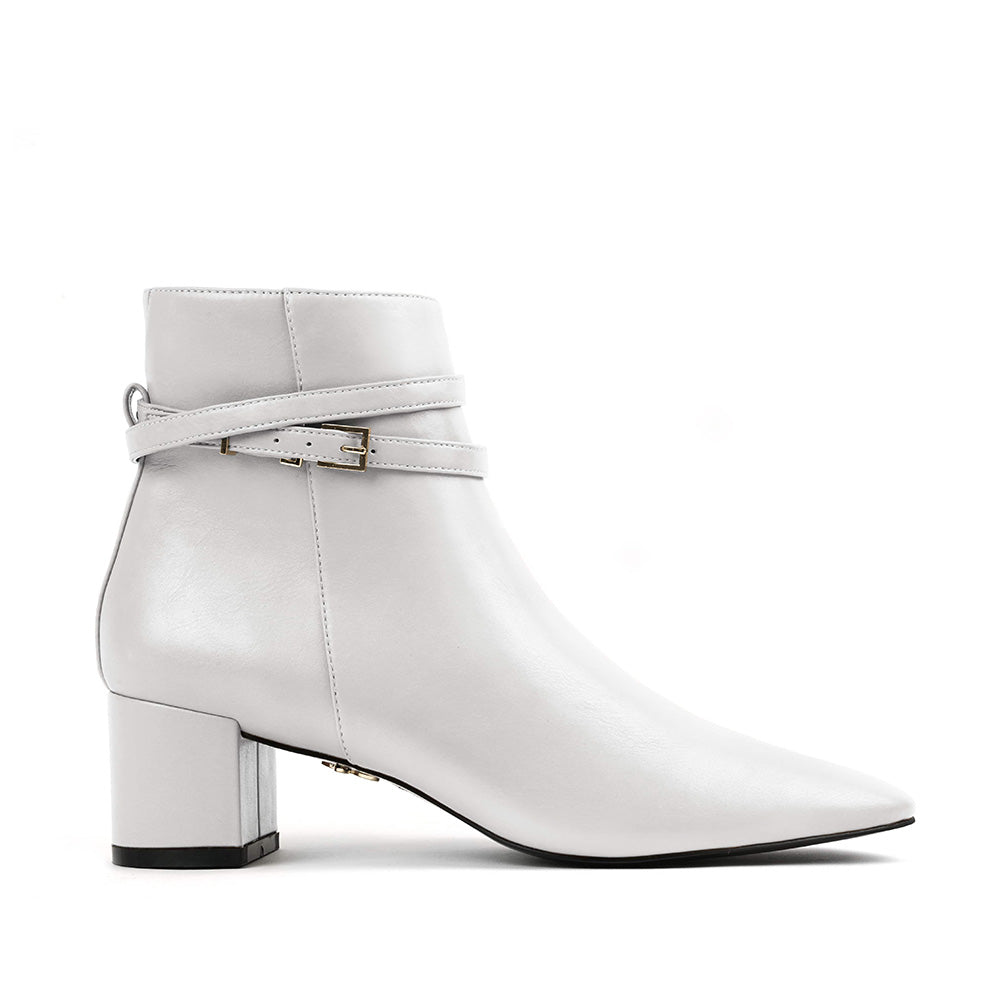 White vegan leather ankle boot with block heel and double wrap ankle straps – sleek and modern women's vegan footwear for versatile styling.