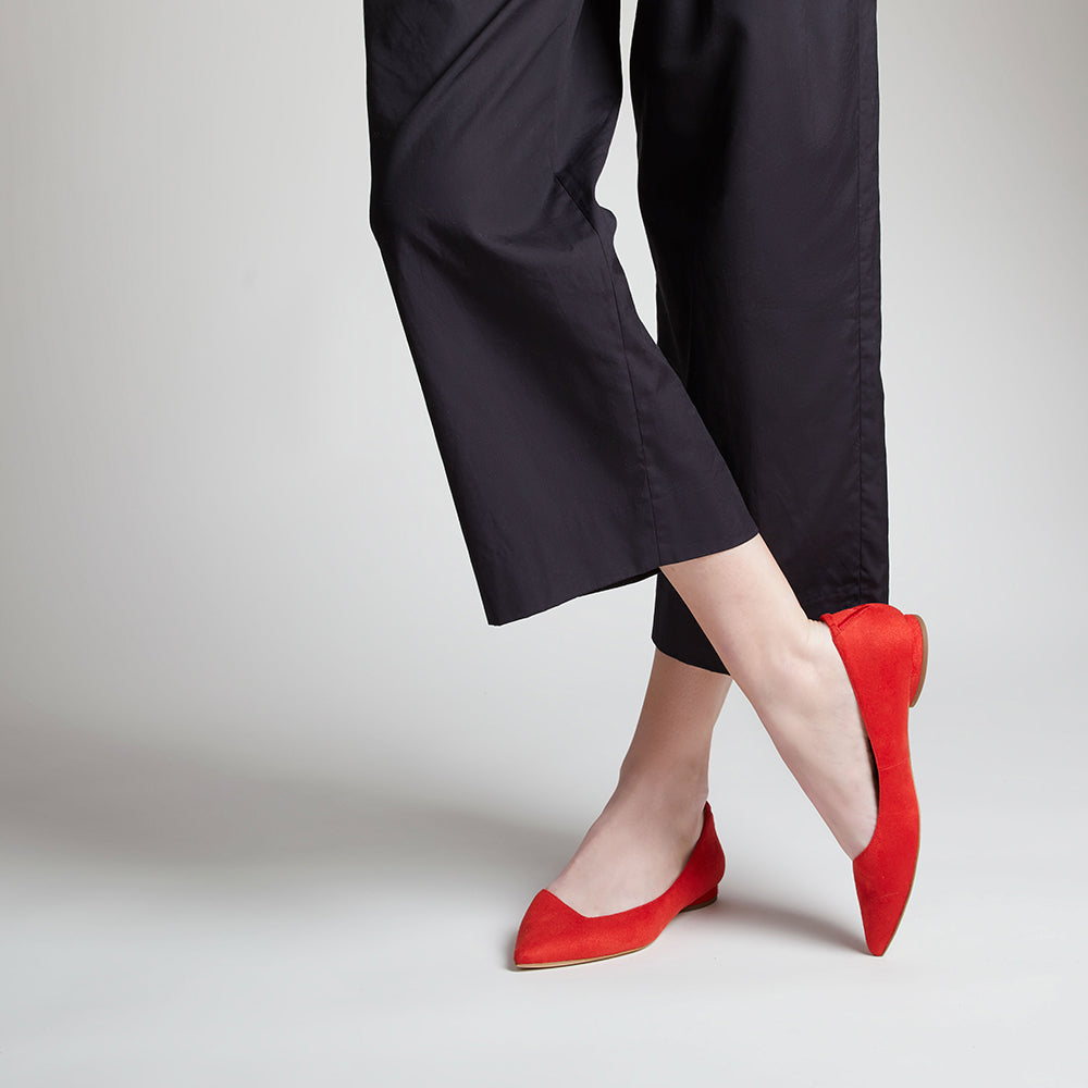 Red vegan faux suede pointed-toe ballet flats with an asymmetric v-vamp and low heel